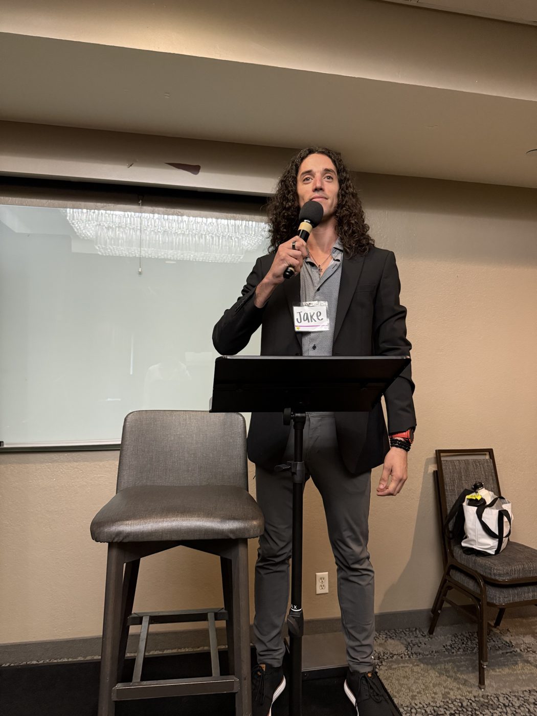Jake Jackson at a lectern with a microphone